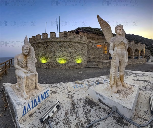 Photo at dusk evening mood of illuminated monument to Daedalus and Icarus on cliff of flight for
