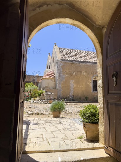 View through door Tor tor archway archway on back of two-aisled church building church monastery