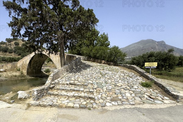 View of stairway with coarse cobblestones of historic classical arched stone bridge in Venetian