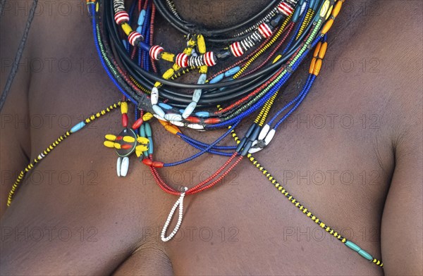 Detail, traditional necklace of a Hakaona woman, pearl necklaces with pendants, in the morning