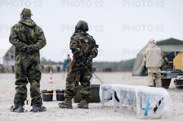 German soldiers from an NBC defence unit in protective clothing practise decontamination during the