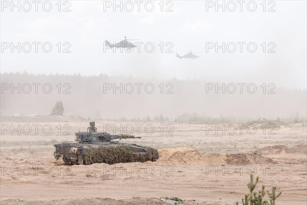 A Cougar infantry fighting vehicle and two Tiger combat helicopters, photographed during the NATO