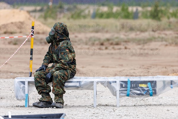 German soldiers from an NBC defence unit in protective clothing practise decontamination during the