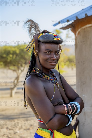 Hakaona woman with traditional kapapo hairstyle and hair ornaments with ostrich feathers and