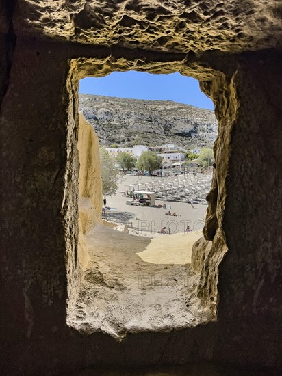 View from cave dwelling of former Roman necropolis later living cave for hippies dropouts on beach