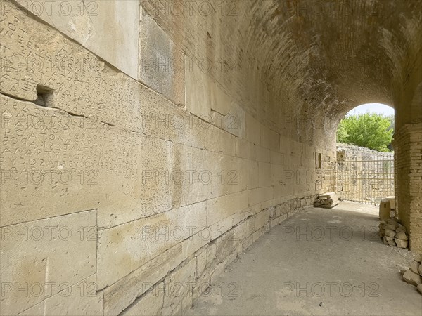 Wall of archway behind amphitheatre carved written chiselled laws City law of Gortys carved in