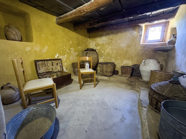 Historic small living room cell of monk Monk's cell with baskets and chairs in UNESCO World