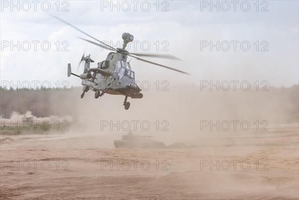 A Cougar infantry fighting vehicle and two Tiger combat helicopters, photographed during the NATO