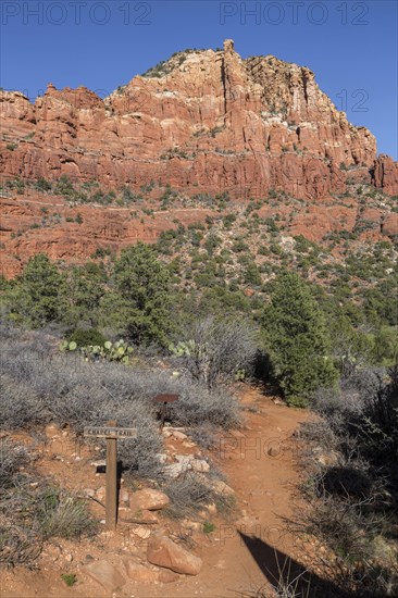 Trail marker sign for the Chapel Trail through red rock sandstone formations in Sedona, Arizona,