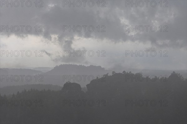 View from the goat's back in Saxon Switzerland during a thunderstorm, cloudburst, Hohnstein,