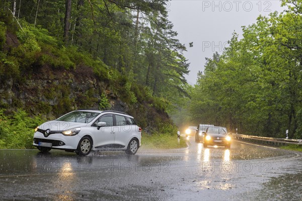 Car traffic during a thunderstorm in the Saxon Switzerland, cloudburst, Hohnstein, Saxony, Germany,