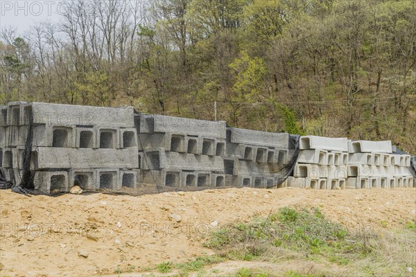 Concrete square culvert sections at base of hillside at rural construction site in Daejeon, South