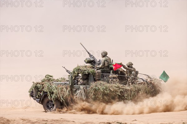 Dutch soldiers on a camouflaged Serval during the NATO Steadfast Defender large-scale manoeuvre in