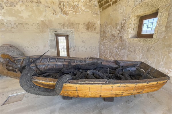 Photo of artwork by Museum of Contemporary Art Refugee boat of migrants and seven snakes made of