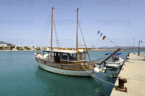 Old wooden sailing boat moored to quay wall in Kokkinos Pyrgos harbour, Kokkinos Pyrgos, Crete,