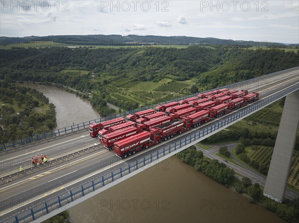 Trucks with a total weight of 960 tonnes stand on the Moselle valley bridge in Winningen during a