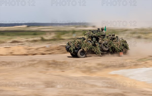 Dutch soldiers on a camouflaged Serval during the NATO Steadfast Defender large-scale manoeuvre in