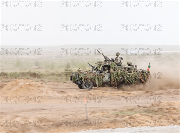Dutch soldiers on a camouflaged Serval during the NATO Steadfast Defender large-scale manoeuvre in
