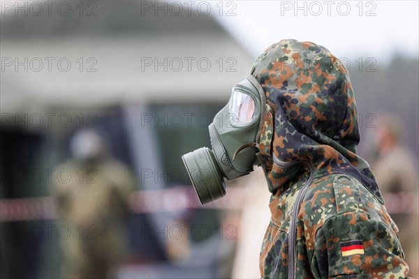 German soldiers from an NBC defence unit in protective clothing practise decontamination during the