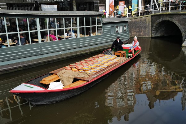 A load of Beemster cheese being transported on a canal in the city centre on market day. Alkmaar,