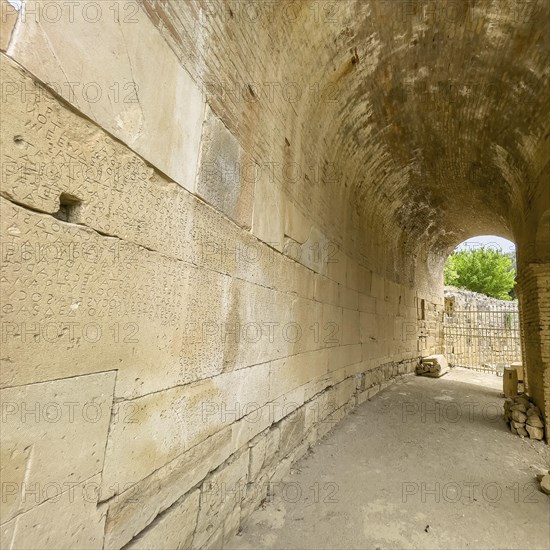 Wall of archway behind amphitheatre carved written chiselled laws City law of Gortys carved in