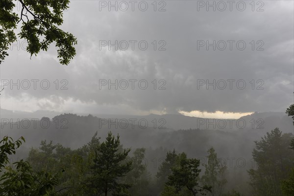 View from the goat's back in Saxon Switzerland during a thunderstorm, cloudburst, Hohnstein,