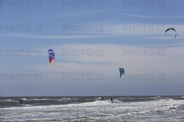 Kite surfers enjoy the waves on a glorious day along the Dutch coast. Castricum, Netherlands