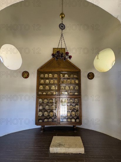 Historic ossuary with cabinet Showcase with old skulls skeletonised heads of monks from UNESCO