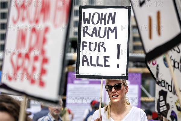 Woman holding a poster with the inscription Wohnraum fuer alle! Demo under the motto The rent is