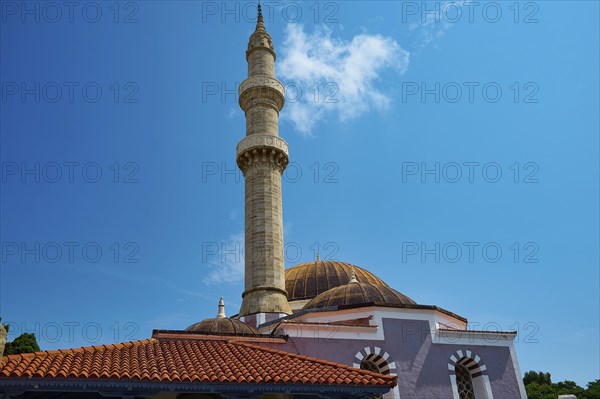 Suleiman Mosque, minaret and dome under blue sky with few clouds, red roofs and historical
