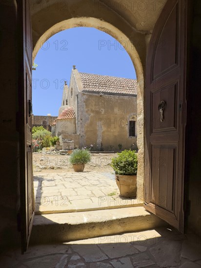 View through door Tor tor archway archway on back of two-aisled church building church monastery