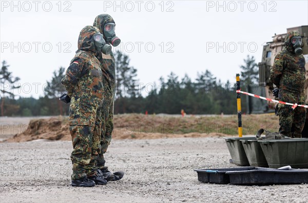 German soldiers from an NBC defence unit in protective clothing practise decontamination during the