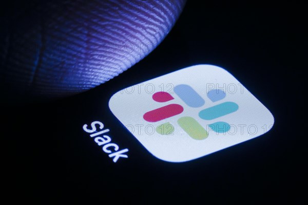 The Slack app icon can be seen on a smartphone. Berlin, 30.05.2024