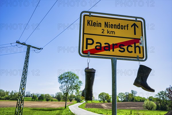 Boots on town sign, farmers' protest, Paarsch, Rome, Mecklenburg-Western Pomerania, Germany, Europe