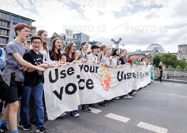 Demonstrators with signs at Fridays for Future in front of the Reichstag building, taken during the
