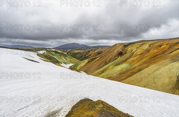 Colourful volcanic landscape with hills and snow, Laugavegur trekking trail, Landmannalaugar,