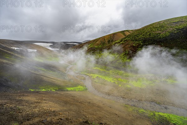 Colourful volcanic landscape with hills and snow, volcanic steaming hot springs, Laugavegur