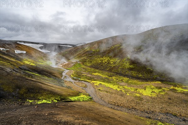 Colourful volcanic landscape with hills and snow, volcanic steaming hot springs, Laugavegur
