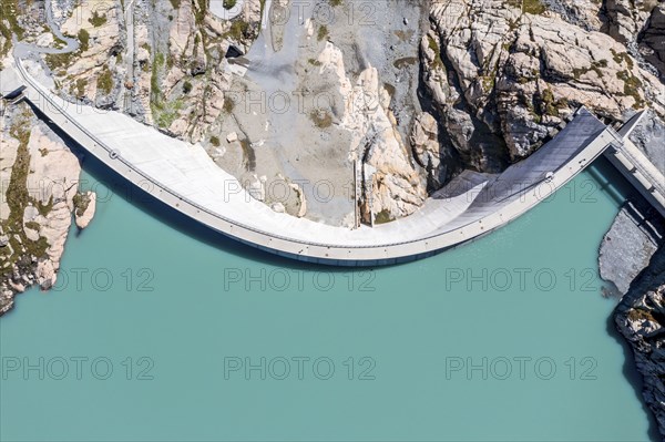 Aerial view of reservoir dam Barrage du Vieux Emosson and mountain hut Cabane Vieux Emosson,