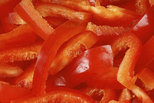 Organic background made of red bell pepper slices