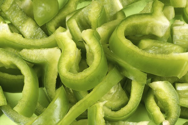 Organic background made of green bell pepper slices
