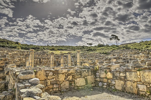 HDR, Super wide angle shot, Ancient ruins with stone walls under a dramatic cloudy sky, Atrium
