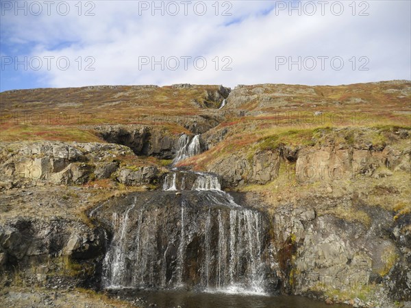 Autumn landscape with waterfall at Isafjordur in the northwest of Iceland