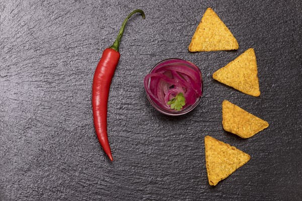 Onion salsa with chips on slate