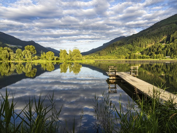 Footbridge leading into a lake, Gaishorner See in the evening light, Gaishorn am See, Paltental,