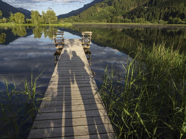 Shadow of a couple on a jetty, Gaishorner See in the evening light, Gaishorn am See, Paltental,