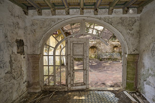 Abandoned building with arched doorway overlooking a dilapidated courtyard, Mussolini Villa, Villa