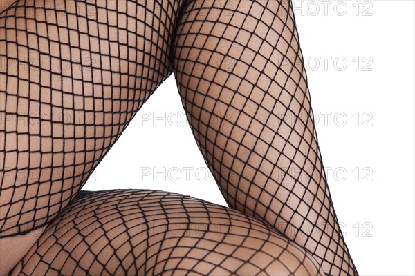 Women's feet in fishnet stockings