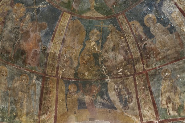 Large, weathered dome mural with numerous holy figures and religious scenes in a church, Byzantine