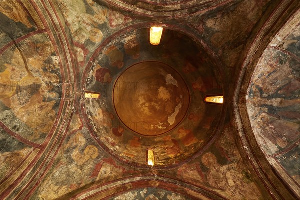 View inside a dome with ancient murals and ornate decorations, Byzantine chapel of Agios Nikolaos